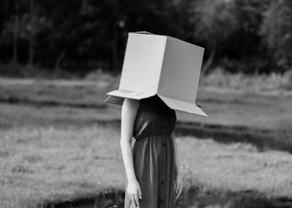 mulher com caixa na cabeça